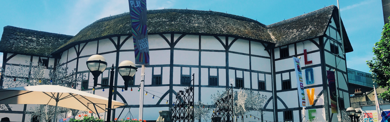 The exterior of Shakespere's globe on a sunny day in London. The globe mimics 17th century London architecture.